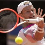 
              Diego Schwartzman returns the ball to Miomir Kekmanovic during their match at the Italian Open tennis tournament, in Rome, Tuesday, May 10, 2022. (AP Photo/Andrew Medichini)
            