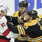 
              Carolina Hurricanes' Jesperi Kotkaniemi, of Finland (82) grapples with Boston Bruins' Charlie Coyle (13), right, as Bruins' Josh Brown (44), behind, looks on in the first period of Game 4 of an NHL hockey Stanley Cup first-round playoff series, Sunday, May 8, 2022, in Boston. (AP Photo/Steven Senne)
            