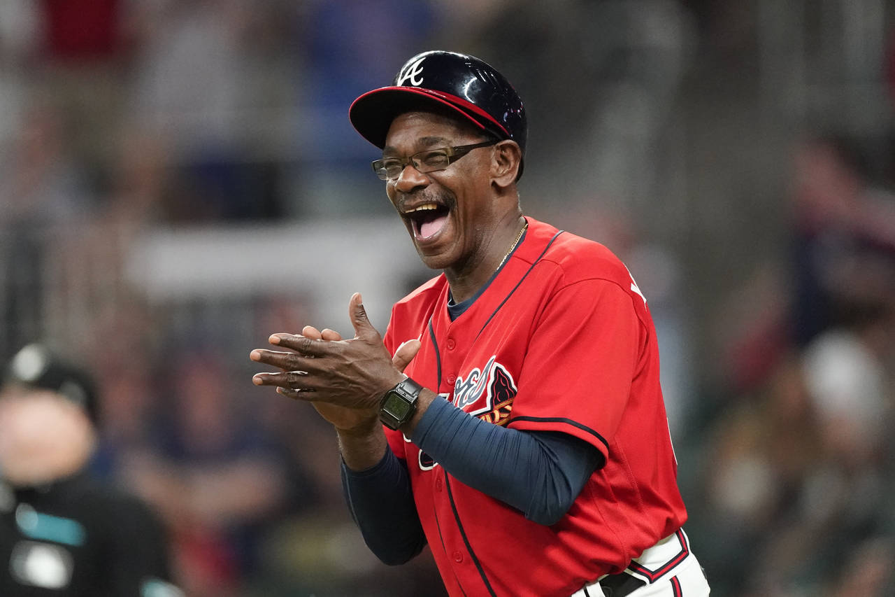 Atlanta Braves third base coach Ron Washington reacts after a three-run home run by Dansby Swanson ...