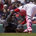 
              Boston Red Sox catcher Christian Vazquez checks on home plate umpire Ron Kulpa after being hit with a foul ball during the fourth inning of a baseball game between the Boston Red Sox and the Chicago White Sox at Fenway Park, Sunday, May 8, 2022, in Boston. (AP Photo/Mary Schwalm)
            