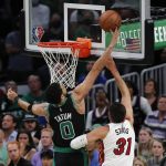 
              Boston Celtics' Jayson Tatum (0) blocks a shot by Miami Heat's Max Strus (31) during the first half of Game 6 of the NBA basketball playoffs Eastern Conference finals Friday, May 27, 2022, in Boston. (AP Photo/Michael Dwyer)
            