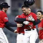 
              Cleveland Guardians' Steven Kwan, center, celebrates with Owen Miller, left, Austin Hedges and Andrés Giménez, right, after driving in the winning run against the San Diego Padres during the 10th inning in the second baseball game of a doubleheader Wednesday, May 4, 2022, in Cleveland. (AP Photo/Ron Schwane)
            