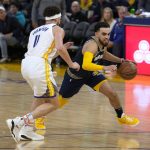 
              Memphis Grizzlies guard Tyus Jones, right, dribbles around Golden State Warriors guard Klay Thompson (11) during the second half of Game 4 of an NBA basketball Western Conference playoff semifinal in San Francisco, Monday, May 9, 2022. (AP Photo/Tony Avelar)
            