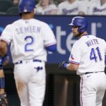 
              Tampa Bay Rays catcher Francisco Mejia, left, stands by the plate as Texas Rangers' Marcus Semien (2) and Eli White (41) score on a Mitch Garver double in the sixth inning of a baseball game, Monday, May 30, 2022, in Arlington, Texas. (AP Photo/Tony Gutierrez)
            
