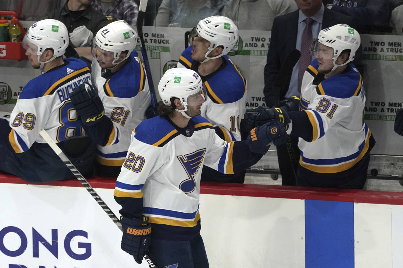 St. Louis Blues' Brandon Saad (20) gets congratulations at the bench after he scored a goal off Min...