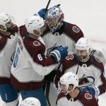 
              Colorado Avalanche goaltender Darcy Kuemper celebrates with teammates Nazem Kadri (91), Erik Johnson (6) and Andrew Cogliano (11) following a 5-2 victory over the St. Louis Blues in Game 3 of an NHL hockey Stanley Cup second-round playoff series Saturday, May 21, 2022, in St. Louis. (AP Photo/Jeff Roberson)
            