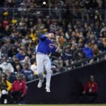 
              Chicago Cubs shortstop Nico Hoerner makes a leaping throw to first for the out on San Diego Padres' Manny Machado during the fourth inning of a baseball game Tuesday, May 10, 2022, in San Diego. (AP Photo/Gregory Bull)
            