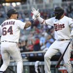 
              Minnesota Twins' Jose Miranda (64) high-fives Royce Lewis (23) after Miranda hit a home run during the second inning of the team's baseball game against the Oakland Athletics, Friday, May 6, 2022, in Minneapolis. (AP Photo/Stacy Bengs)
            