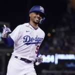 
              Los Angeles Dodgers' Mookie Betts celebrates as he rounds third after hitting a solo home run during the sixth inning of a baseball game against the Los Angeles Dodgers Wednesday, May 4, 2022, in Los Angeles. (AP Photo/Mark J. Terrill)
            