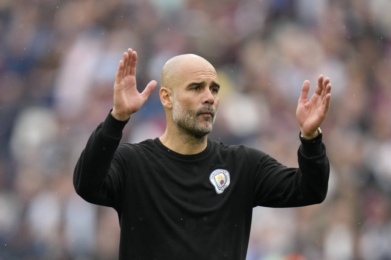 Manchester City's head coach Pep Guardiola reacts at the end of the English Premier League soccer m...