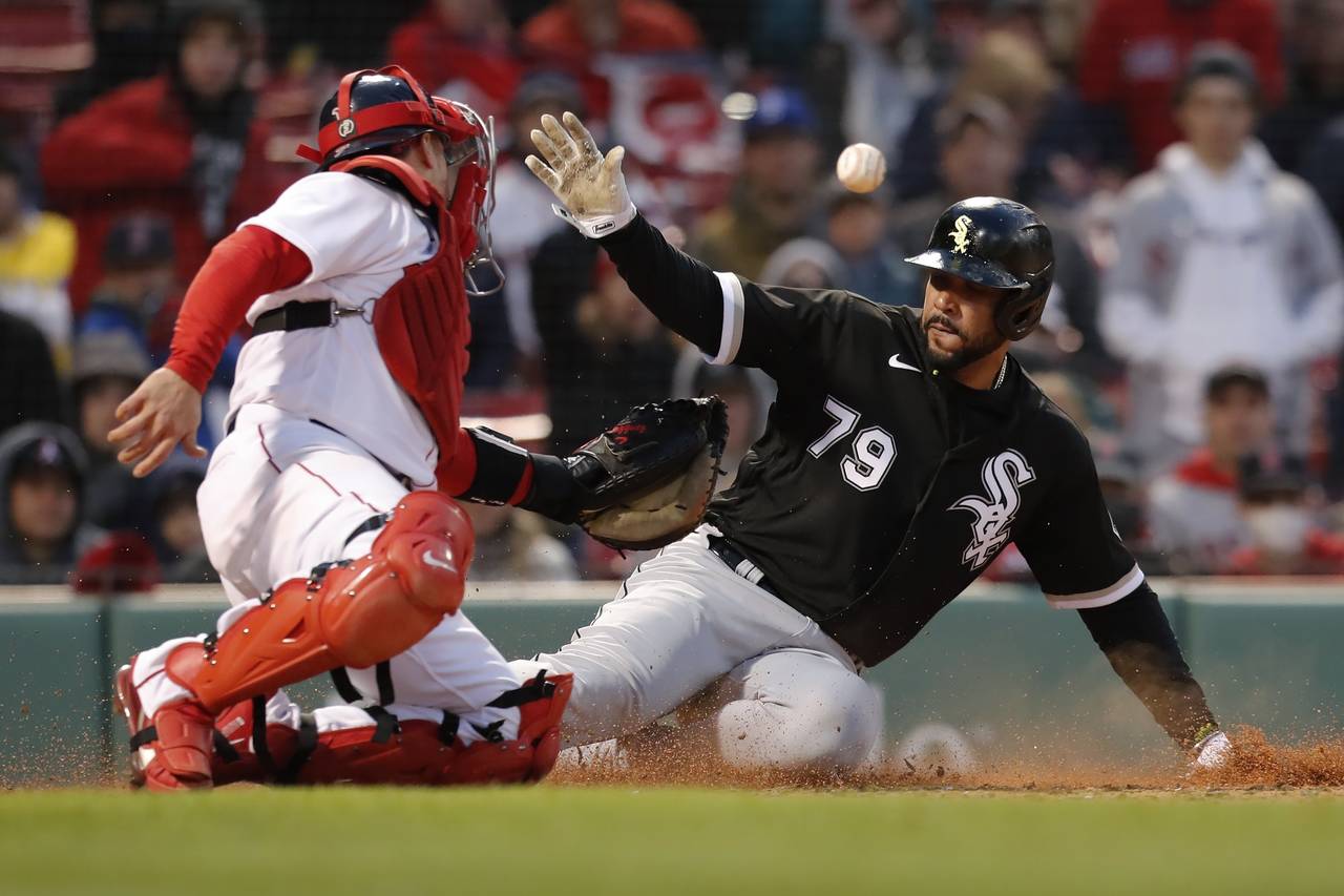 Chicago White Sox's Jose Abreu (79) is safe at home plate against Boston Red Sox's Christian Vazque...