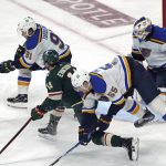 
              Minnesota Wild's Joel Eriksson Ek (14) races for the puck as St. Louis Blues' Vladimir Tarasenko (91) and goalie Ville Husso (35) defend , while Colton Parayko (55) trips during the second period of Game 2 of an NHL hockey Stanley Cup first-round playoff series Wednesday, May 4, 2022, in St. Paul, Minn. (AP Photo/Jim Mone)
            