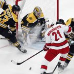 
              Carolina Hurricanes' Nino Niederreiter (21) works against Boston Bruins' Patrice Bergeron (37) in front of goalie Jeremy Swayman (1) during the first period in Game 6 of an NHL hockey Stanley Cup first-round playoff series Thursday, May 12, 2022, in Boston. (AP Photo/Michael Dwyer)
            