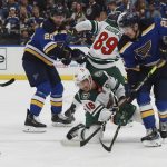 
              St. Louis Blues' Jordan Kyrou (25) and Minnesota Wild's Jared Spurgeon (46) vie for the puck during the second period in Game 6 of an NHL hockey Stanley Cup first-round playoff series Thursday, May 12, 2022, in St. Louis. (AP Photo/Michael Thomas)
            