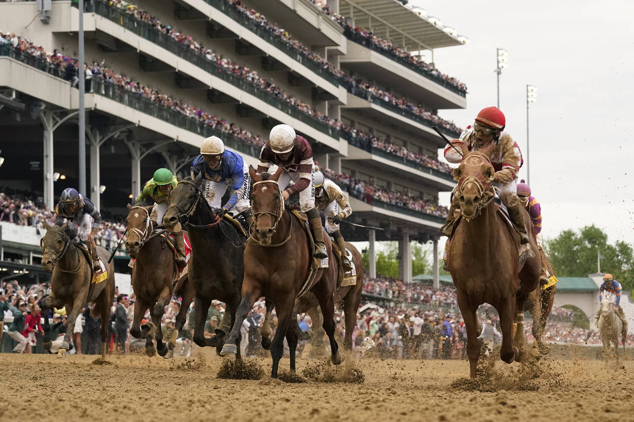 Rich Strike, front right, with Sonny Leon aboard, wins the 148th running of the Kentucky Derby hors...