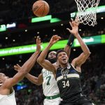 
              Boston Celtics center Al Horford, left, and guard Jaylen Brown, center, vie for a rebound with Milwaukee Bucks forward Giannis Antetokounmpo, right, during the first half of Game 7 of an NBA basketball Eastern Conference semifinals playoff series, Sunday, May 15, 2022, in Boston. (AP Photo/Steven Senne)
            