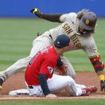 
              Cleveland Guardians' Andrés Giménez tags out San Diego Padres' Jorge Alfaro at second base during the first inning in the second baseball game of a doubleheader, Wednesday, May 4, 2022, in Cleveland. (AP Photo/Ron Schwane)
            