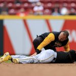 
              Pittsburgh Pirates' athletic trainer Rafael Freitas, top, tends to Roberto Perez after he was injury during the eighth inning in the first baseball game of a doubleheader against the Cincinnati Reds in Cincinnati, Saturday, May 7, 2022. The Reds won 9-2. (AP Photo/Aaron Doster)
            