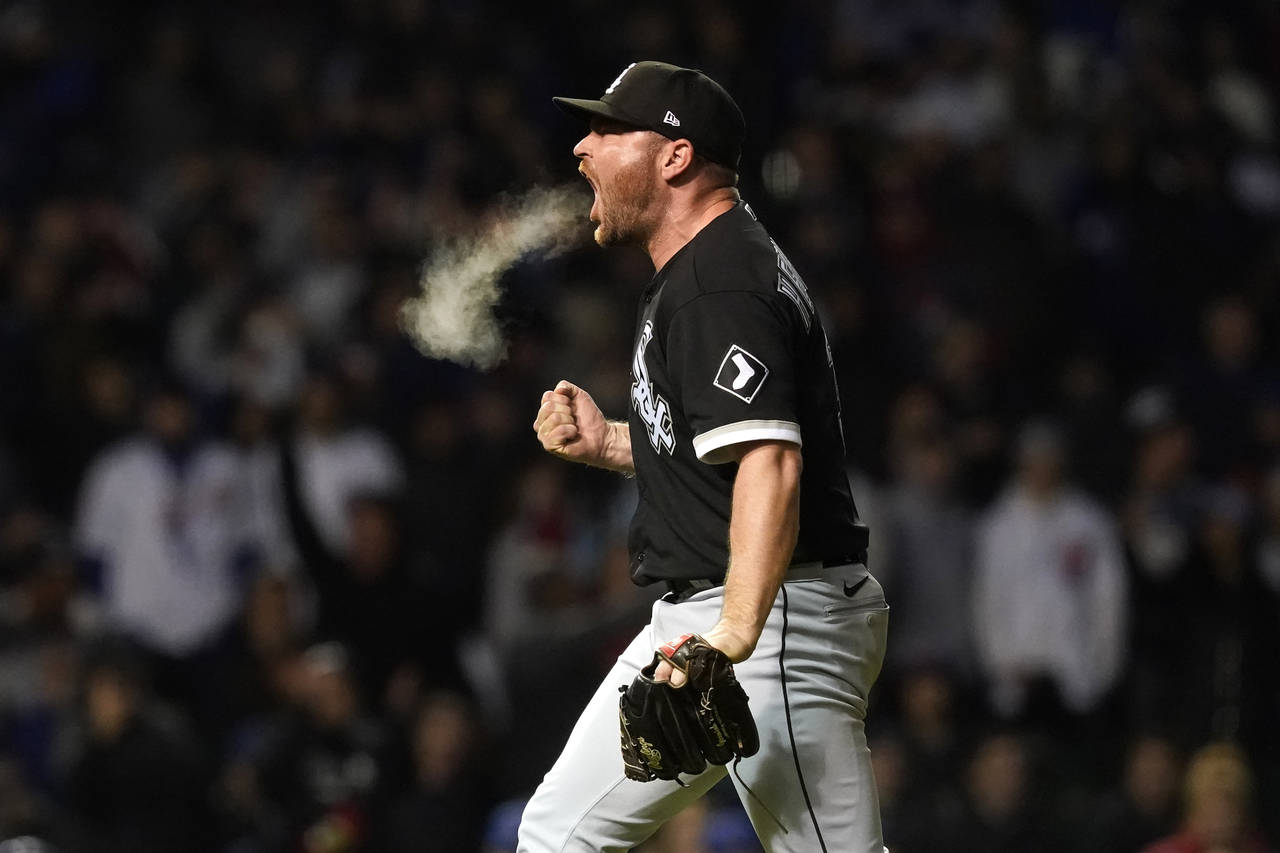 Chicago White Sox relief pitcher Liam Hendriks reacts after striking out Chicago Cubs' Nico Hoerner...
