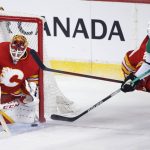 
              Calgary Flames goalie Jacob Markstrom stops Dallas Stars defenseman Jani Hakanpaa (2) during the first period of Game 5 of an NHL hockey Stanley Cup first-round playoff series, Wednesday, May 11, 2022 in Calgary, Alberta. (Larry MacDougal/The Canadian Press via AP)
            
