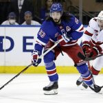 
              New York Rangers center Mika Zibanejad (93) passes in front of Carolina Hurricanes defenseman Brady Skjei in the first period of Game 3 of an NHL hockey Stanley Cup second-round playoff series, Sunday, May 22, 2022, in New York. (AP Photo/Adam Hunger)
            