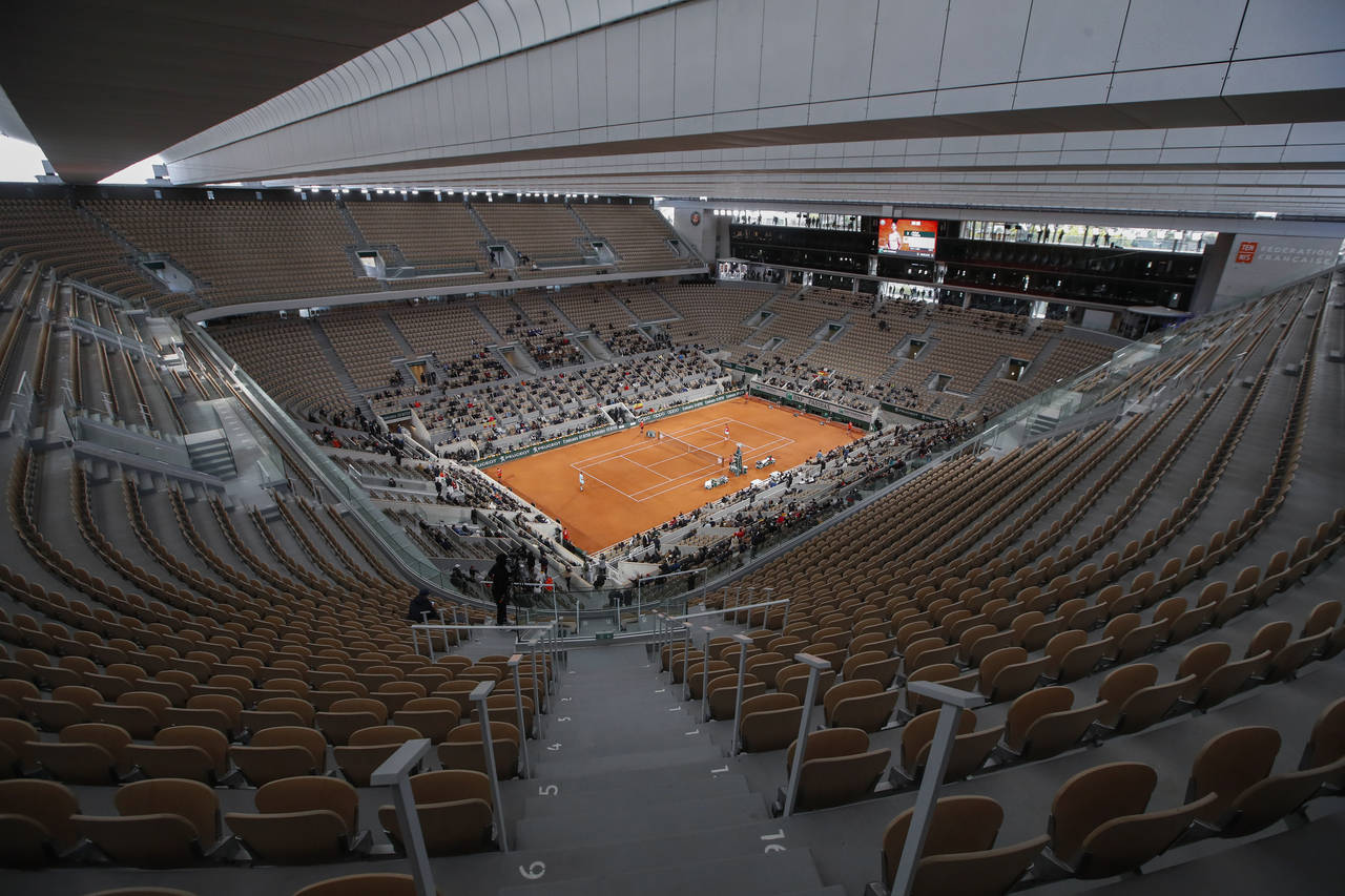 FILE - Rows of empty seats are seen at centre court at the Roland Garros stadium in Paris Sunday, O...
