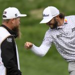 
              Max Homa celebrates with his caddie after winning the Wells Fargo Championship golf tournament, Sunday, May 8, 2022, at TPC Potomac at Avenel Farm golf club in Potomac, Md. (AP Photo/Nick Wass)
            