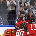 
              Team of Canada celebrates a overtime goal scored by Drake Batherson, during the Hockey World Championship quarterfinal match between Sweden and Canada in Tampere, Finland, Thursday, May 26, 2022. (Vesa Moilanen/Lehtikuva via AP)
            