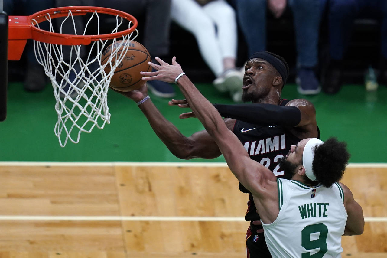 Boston Celtics guard Derrick White (9) pressures Miami Heat forward Jimmy Butler (22) on a shot dur...