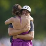 
              Sam Burns, right, hugs his wife Caroline Burns after winning the Charles Schwab Challenge golf tournament at the Colonial Country Club in Fort Worth, Texas, Sunday, May 29, 2022. (AP Photo/LM Otero)
            