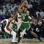 
              Boston Celtics forward Jayson Tatum (0) looks to pass the ball under pressure from Miami Heat guards Gabe Vincent (2) and Victor Oladipo during the second half of Game 2 of the NBA basketball Eastern Conference finals playoff series, Thursday, May 19, 2022, in Miami. (AP Photo/Lynne Sladky)
            