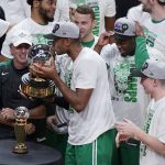 
              Boston Celtics center Al Horford kisses the NBA Eastern Conference trophy after defeated the Miami Heat in Game 7 of the NBA basketball Eastern Conference finals playoff series, Sunday, May 29, 2022, in Miami. (AP Photo/Wilfredo Lee)
            