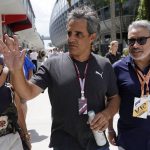 
              Indy car driver Juan Pablo Montoya, center, arrives for the third practice session for the Formula One Miami Grand Prix auto race at the Miami International Autodrome, Saturday, May 7, 2022, in Miami Gardens, Fla. (AP Photo/Lynne Sladky)
            