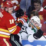 
              Calgary Flames defenseman Nikita Zadorov (16) checks Dallas Stars center Radek Faksa (12) during the second period of Game 5 of an NHL hockey Stanley Cup first-round playoff series, Wednesday, May 11, 2022 in Calgary, Alberta. (Larry MacDougal/The Canadian Press via AP)
            