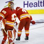 
              Calgary Flames defenseman Rasmus Andersson, right, and goalie Jacob Markstrom, react to the team's overtime loss to the Edmonton Oilers in Game 5 of an NHL hockey second-round playoff series Thursday, May 26, 2022, in Calgary, Alberta. (Jeff McIntosh/The Canadian Press via AP)
            