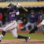 
              Minnesota Twins' Byron Buxton (25) hits an RBI-single in front of Oakland Athletics catcher Sean Murphy during the fifth inning of a baseball game in Oakland, Calif., Monday, May 16, 2022. (AP Photo/Jeff Chiu)
            