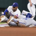 
              Kansas City Royals Hunter Dozier (17) steals second base as Texas Rangers second baseman Andy Ibanez awaits the throw during the fourth inning of a baseball game in Arlington, Texas, Thursday, May 12, 2022. (AP Photo/LM Otero)
            