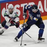 
              Finland's Teemu Hartikanen and Thomas Bordeleau of the United States work for the puck during a match between Finland and the the United States in the semifinals of the Hockey World Championships, in Tampere, Finland, Saturday, May 28, 2022. (AP Photo/Martin Meissner)
            