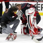 
              Carolina Hurricanes head athletic trainer Doug Bennett examines goaltender Antti Raanta (32) during the first period of Game 2 of the team's NHL hockey Stanley Cup first-round playoff series against the Boston Bruins in Raleigh, N.C., Wednesday, May 4, 2022. (AP Photo/Karl B DeBlaker)
            