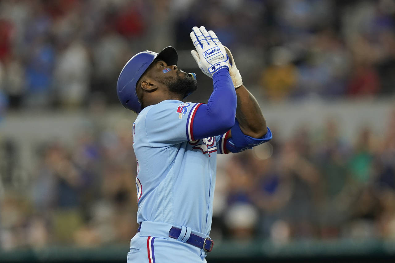 Texas Rangers' Adolis Garcia looks up as he runs the bases after hitting a two-run home run during ...