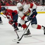 
              Washington Capitals defenseman Nick Jensen (3) reaches for the puck against Florida Panthers defenseman Aaron Ekblad (5) during the second period of Game 6 in the first round of the NHL Stanley Cup hockey playoffs, Friday, May 13, 2022, in Washington. (AP Photo/Alex Brandon)
            