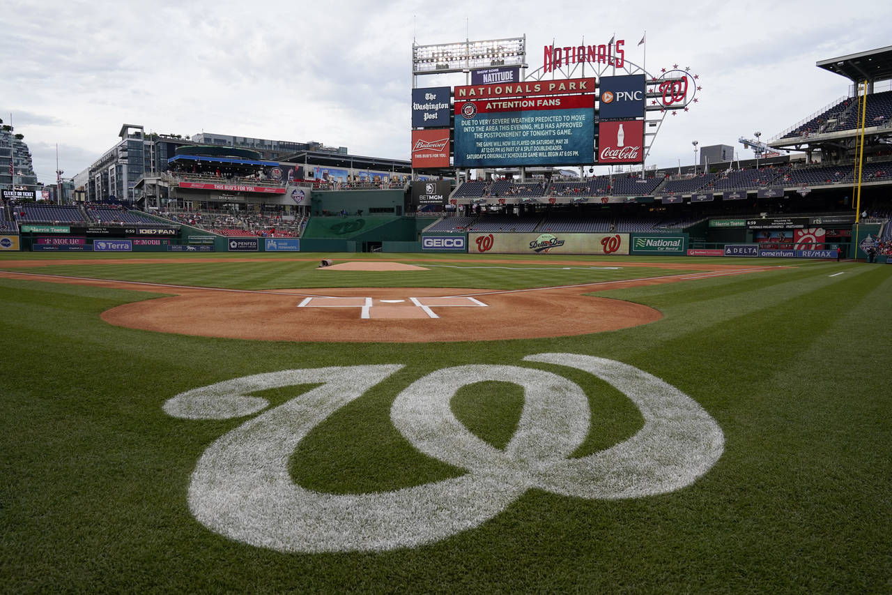 A message on the outfield screen announces the postponement of a baseball game between the Colorado...