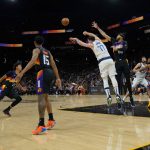 
              Dallas Mavericks guard Luka Doncic (77) passes the ball down court past Phoenix Suns center JaVale McGee (00) during the first half of Game 2 in the second round of the NBA Western Conference playoff series Wednesday, May 4, 2022, in Phoenix. (AP Photo/Matt York)
            