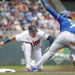 
              Minnesota Twins third baseman Gio Urshela, left, tags out Kansas City Royals' Bobby Witt on a fielder's choice hit by Salvador Perez in the first inning of a baseball game Saturday, May 28, 2022, in Minneapolis. (AP Photo/Bruce Kluckhohn)
            