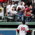 
              Boston Red Sox's Franchy Cordero (16) watches as fans reach for a solo home run by Los Angeles Angels' Brandon Marsh during the ninth inning of a baseball game, Thursday, May 5, 2022, in Boston. (AP Photo/Michael Dwyer)
            