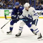 
              Toronto Maple Leafs defenseman Justin Holl (3) and Tampa Bay Lightning center Steven Stamkos (91) battle for the puck during the second period in Game 6 of an NHL hockey first-round playoff series Thursday, May 12, 2022, in Tampa, Fla. (AP Photo/Chris O'Meara)
            