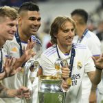 
              Real Madrid's Toni Kroos, Casemiro and Luka Modric, from left to right, pose with the trophy after winning the Champions League final soccer match between Liverpool and Real Madrid at the Stade de France in Saint Denis near Paris, Sunday, May 29, 2022. Real Madrid defeated Liverpool 1-0. (AP Photo/Manu Fernandez)
            