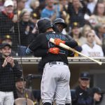 
              Miami Marlins' Joe Dunand, foreground, is congratulated by Jazz Chisholm Jr. after hitting a solo home against the San Diego Padres in the third inning of a baseball game Saturday, May 7, 2022, in San Diego. The home run was Dunand's first career hit. (AP Photo/Derrick Tuskan)
            