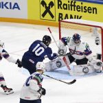 
              Norway's goalie Henrik Haukeland makes a save from Finland's Joel Armia, center, during their preliminary round group B Hockey World Championship match between Finland and Norway in Tampere, Finland, Friday May 13, 2022. (Emmi Korhonen/Lehtikuva via AP)
            