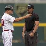 
              Rutgers head coach Steve Owens, left, talks with an umpire as they review a play against Michigan in the first inning of the NCAA college Big Ten baseball championship game Sunday, May 29, 2022, at Charles Schwalb Field in Omaha, Neb. (AP Photo/Rebecca S. Gratz)
            